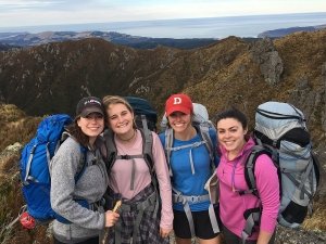 Four students standing on a mountain