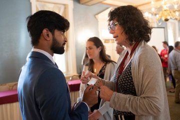 Student and alumna talking